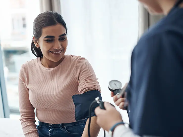 image of a woman getting her blood pressure taken