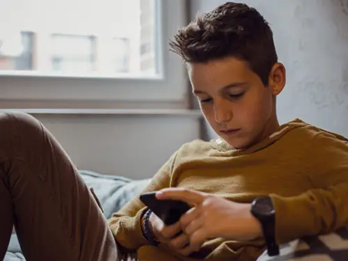 A child looking at his phone
