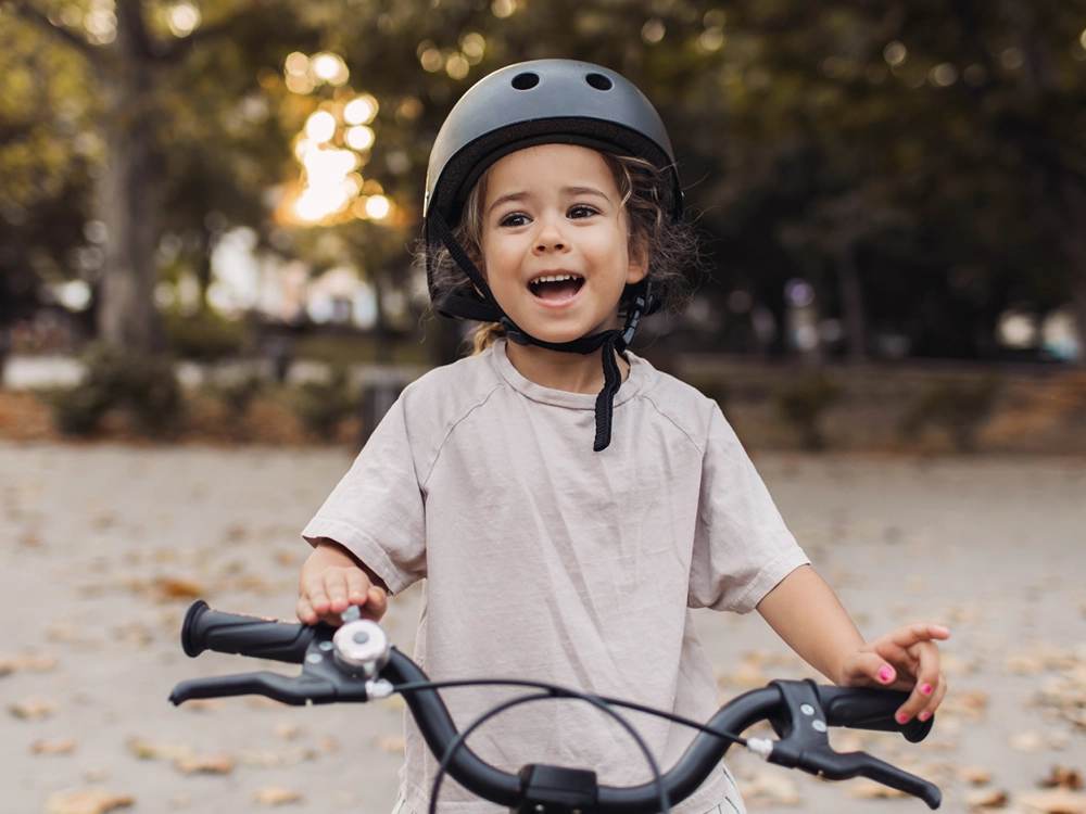 Young boy wearing a helmet while riding a bike