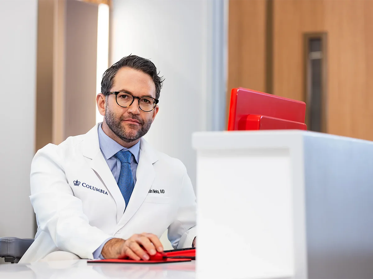 Dr. Neira using a computer