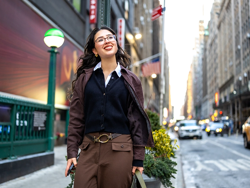 A woman walking down the streets of Manhattan.