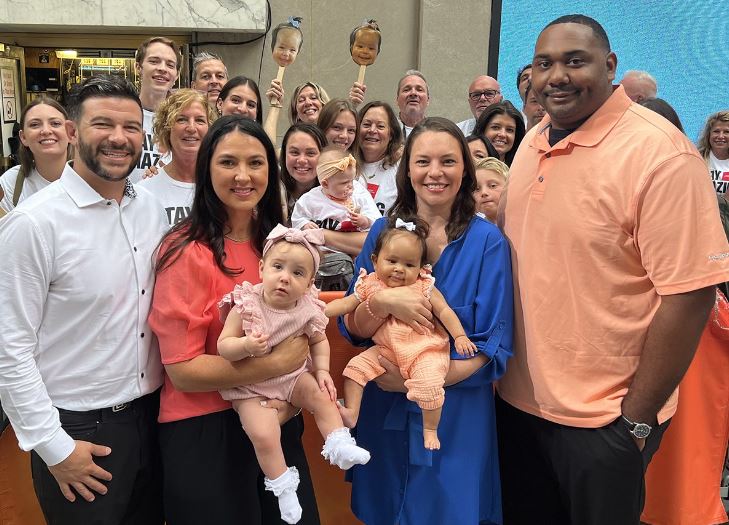 Mia Skaats, now 11 months old, and Brooklyn Civil, 5 months old with their parents and care team